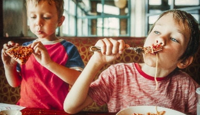 Children eating spaghetti